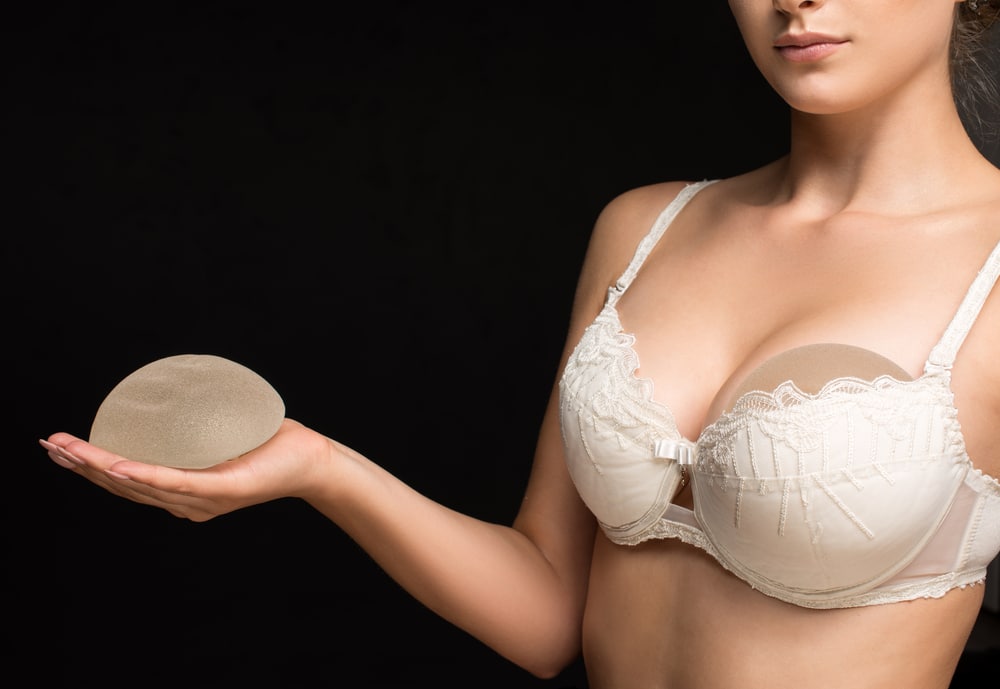 A woman with silicone breast implants in her bra